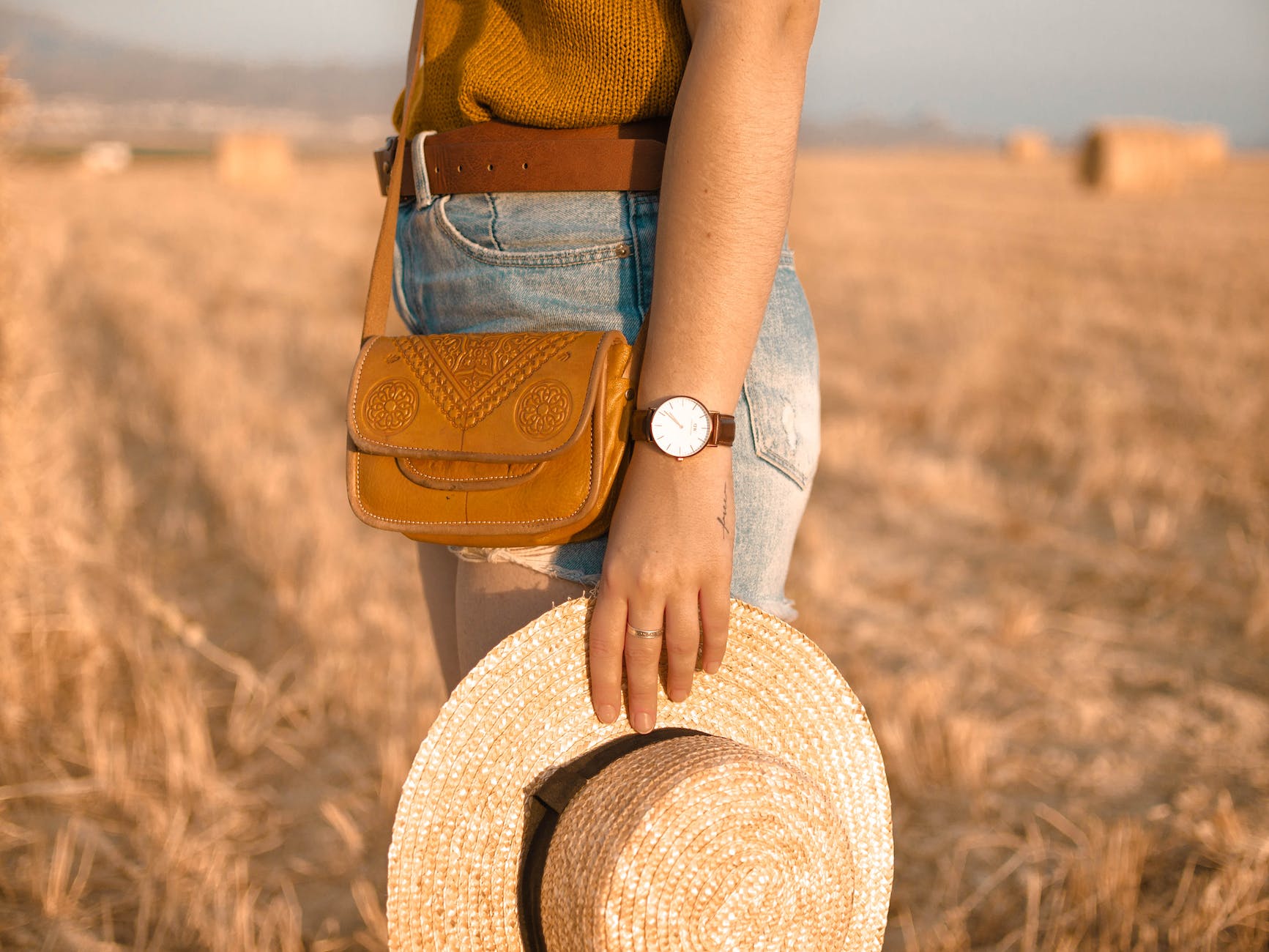 woman holding straw hat watch