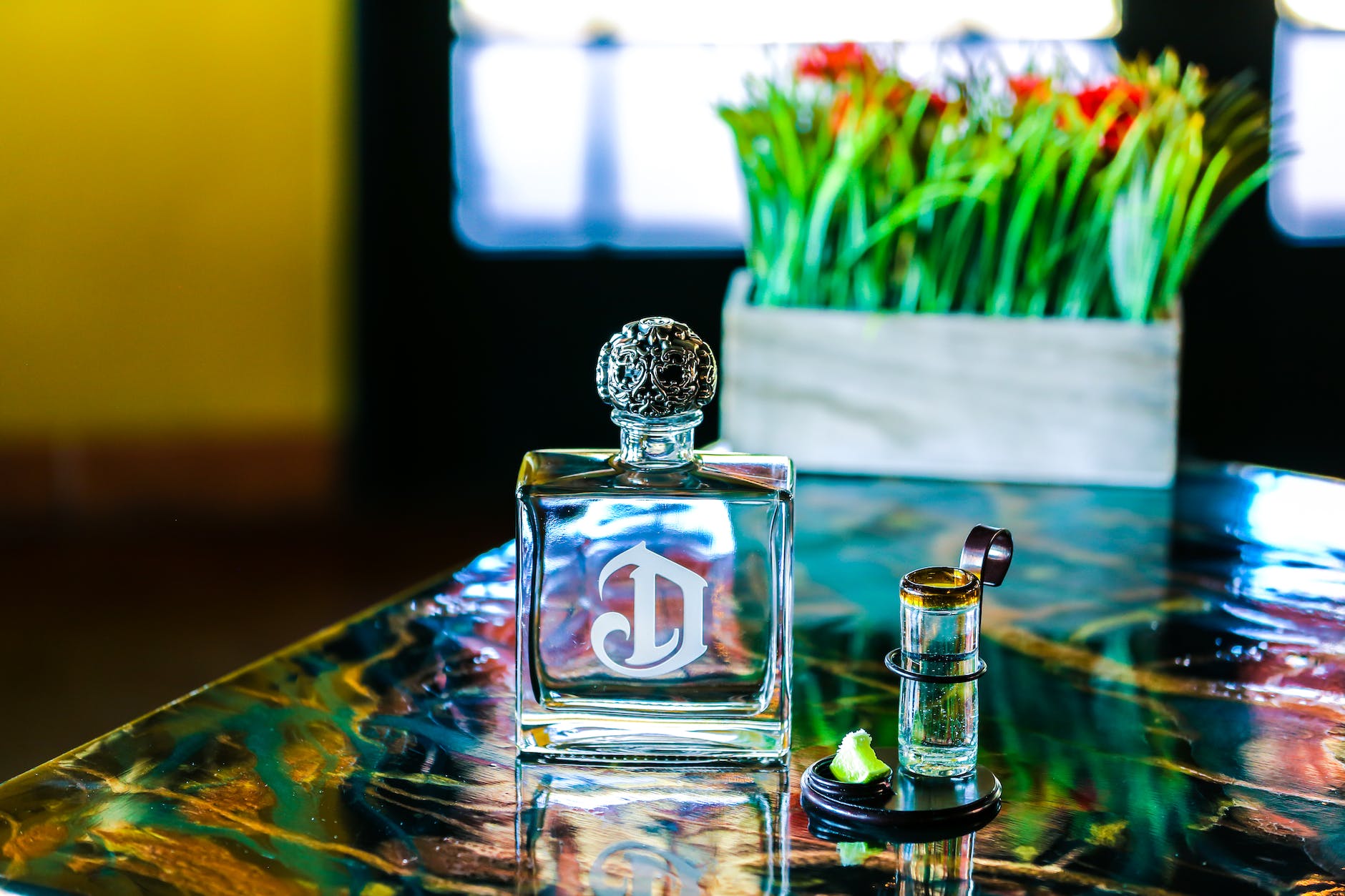 clear glass perfume bottle on table